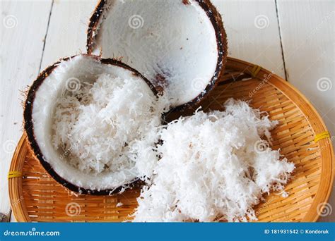 Coconut Shell and Freshly Grated Coconut on Bamboo Tray Stock Photo ...