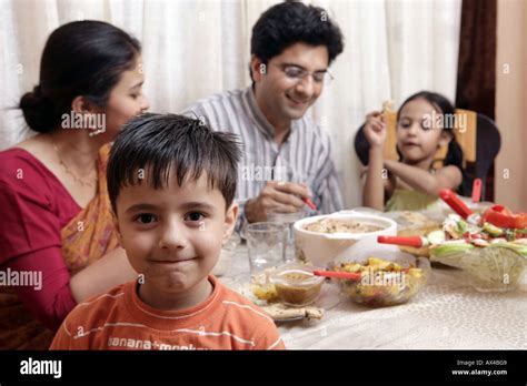 Family eating food at a dining table Stock Photo - Alamy