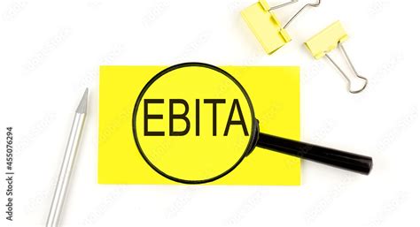 EBITA text on the sticker through magnifier. View from above. Business concept Stock Photo ...