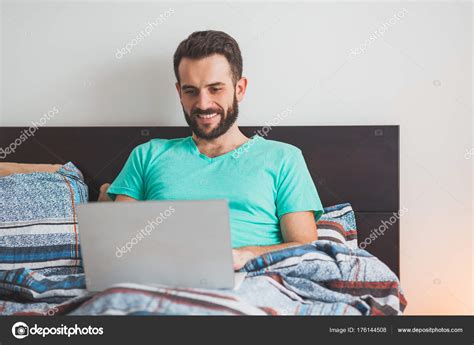 Young Man Lying Bed Working Laptop Stock Photo by ©marjan4782@gmail.com 176144508