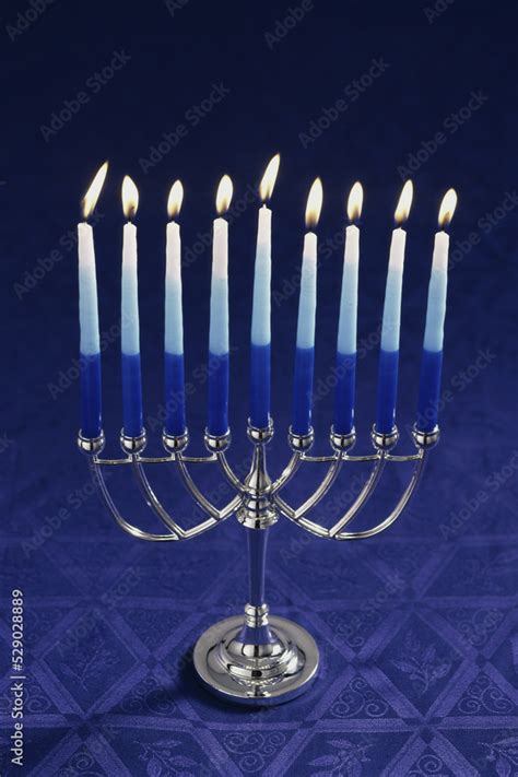 Lit candles on a menorah Stock Photo | Adobe Stock