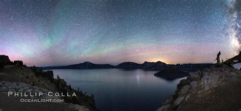 Air glow faint aurora borealis and stars over Crater Lake at night ...