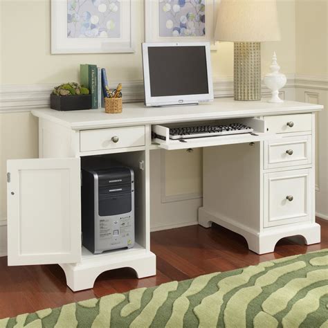 a white computer desk with a laptop on it