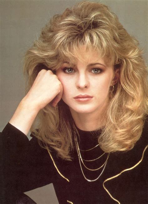 Romantic long 1980s hairstyle with layers around the bangs and face