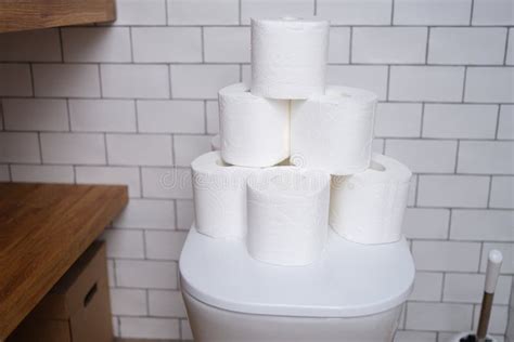 Stack of Toilet Paper Stands on White Toilet in Bathroom Closeup Stock Image - Image of bathroom ...