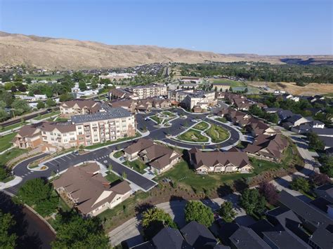 an aerial view of houses in a residential area with mountains in the ...