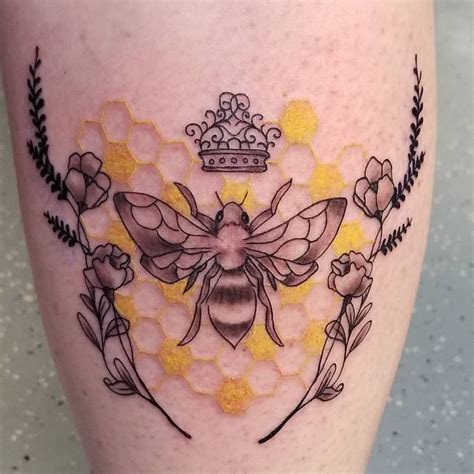 a bee with a crown on its head and flowers around it's legs is shown