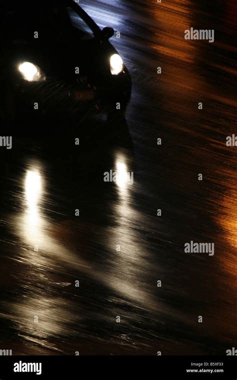 fast car driving in heavy rain at night in town Stock Photo - Alamy