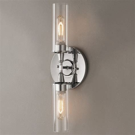 Double the simplicity with this modern clear glass wall sconce. The sleek lines refine the ...