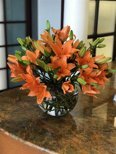 Orange lilies arranged in a glass bowl. Centerpiece, flower arrangement | Orange lily flower ...