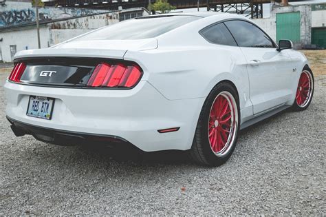 Striking Contrast: Custom Red Vossen Wheels on White Ford Mustang ...