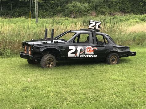 an old race car with the number twenty on it's side parked in a field