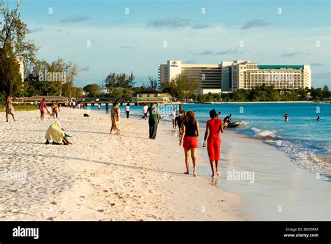 Carlisle bay beach at Barbados with some people walking along it Caribbean Stock Photo - Alamy