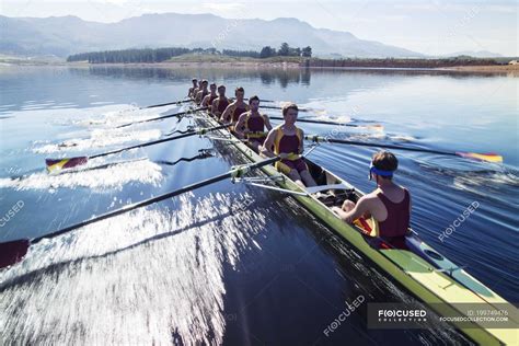 Rowing team rowing scull on lake — effort, Sports Clothing - Stock Photo | #199749476