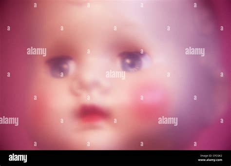 Atmospheric close up of face of traditional baby doll with big staring ...