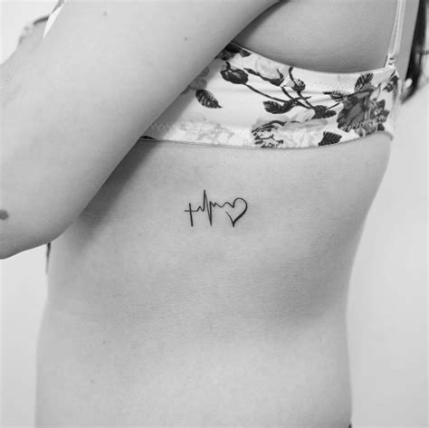 Minimalist Faith Hope Love symbol tattoo done on the