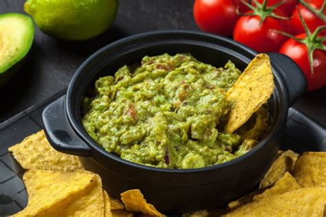 Bowl of Guacamole with Corn Chips Stock Photo - Image of food, green: 65575240