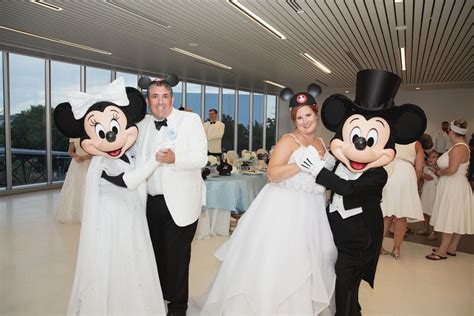 Disney Fairy Tale Wedding couple dance with Mickey and Minnie at their reception in the GM ...