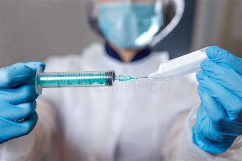 A Medical Worker Types Medicine into a Syringe . Ampoule and Syringe Close-up Stock Image ...