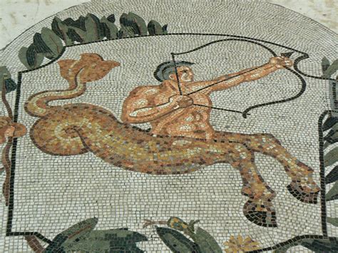 a mosaic with a man on a horse holding a bow and arrow in its hand