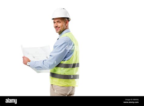 engineer in helmet looking at camera and holding blueprint isolated on ...