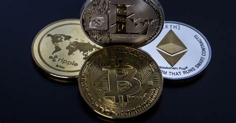 Four Assorted Cryptocurrency Coins · Free Stock Photo