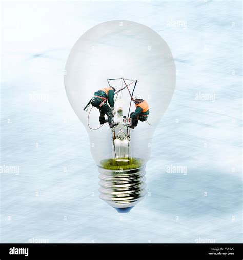 Linemen working inside of clear light bulb Stock Photo - Alamy