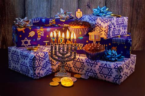 the menorah is next to many wrapped presents with lit candles on them ...