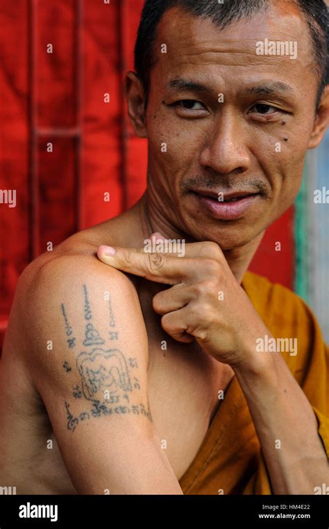 Thai monk shows off his Sak Yan tattoo Stock Photo - Alamy