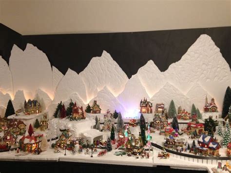 a christmas village is shown with lights and snow on the mountain ...