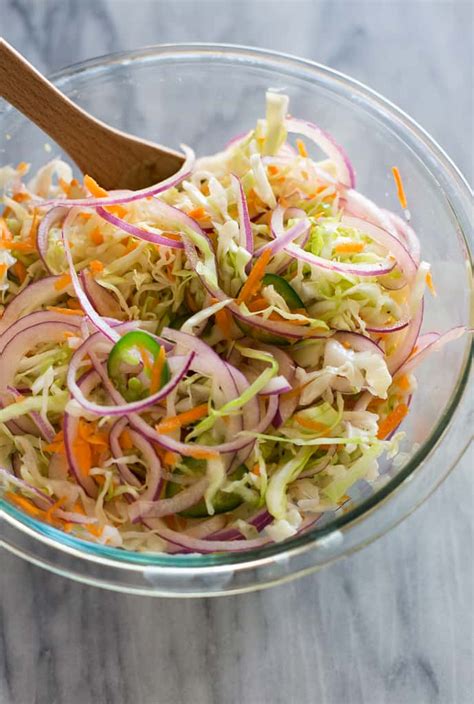 Curtido is a Salvadoran cabbage slaw or relish made with finely shredded cabbage, red onion ...