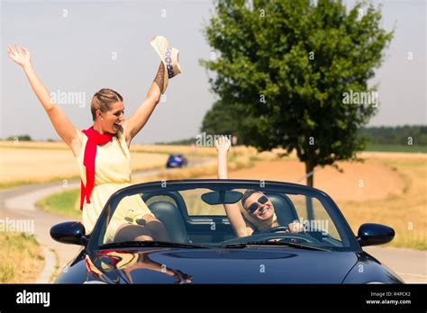 friends having summer joyride in convertible car Stock Photo - Alamy