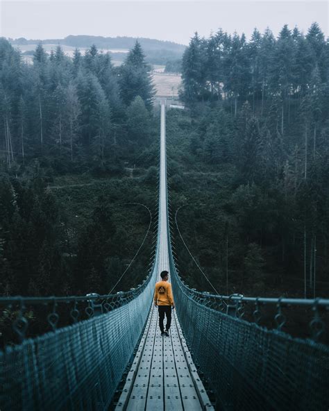 Man Walking On Suspension Bridge · Free Stock Photo