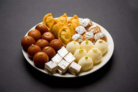 Indian Sweets In A Plate Includes Gulab Jamun Rasgulla Kaju Katli Morichoor Bundi Laddu Gujiya ...