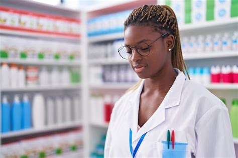 Free Photo | African american woman pharmacist standing with serious expression at pharmacy