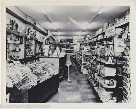 an old black and white photo of a store with shelves full of items in it