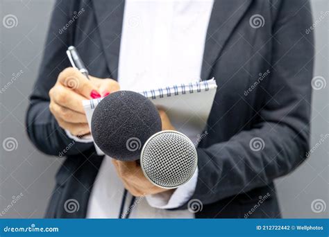 News Reporter or TV Journalist at Press Conference or Media Event, Holding Microphone and ...