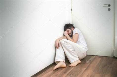 Lonely sad man suffers from depression and crying on floor — Stock Photo © vchalup2 #93511310