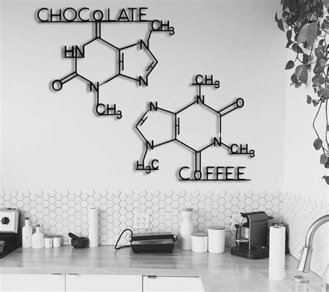 black and white photograph of kitchen counter top with coffee sign above it, on the wall