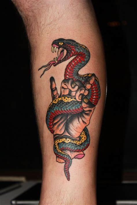 a man's leg with a tattoo on it and a snake crawling out of his arm