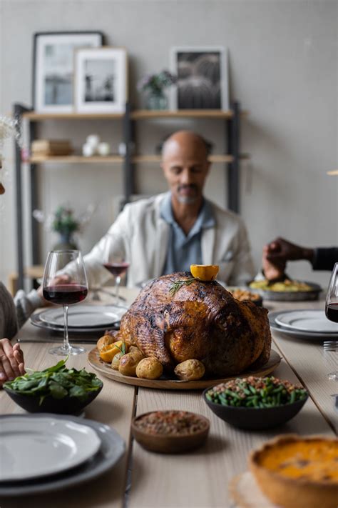 Wooden table served with tasty dishes on Thanksgiving Day · Free Stock Photo