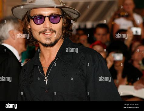 Actor Johnny Depp poses for photographers at film premiere of "Pirates of the Caribbean: Dead ...