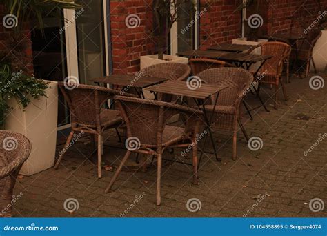 Outdoor Cafe with Wicker Chairs Stock Image - Image of city, iron: 104558895