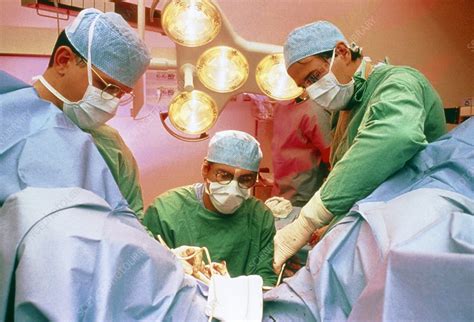 View of surgeons conducting a vaginal operation - Stock Image - M550/0402 - Science Photo Library