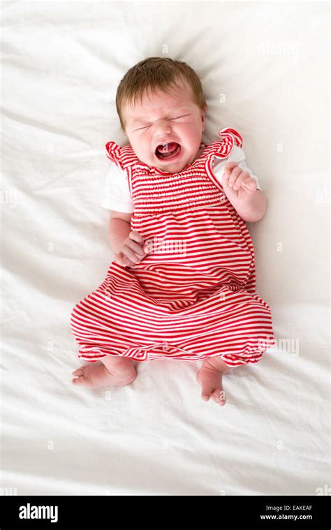 Four day old newborn baby girl crying loudly Stock Photo - Alamy