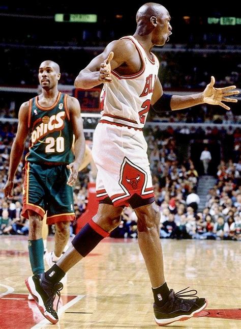 two men playing basketball in front of an audience