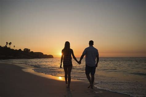 couple holding hands while walking on beach | Couples beach photography, Couples, Beach scenes