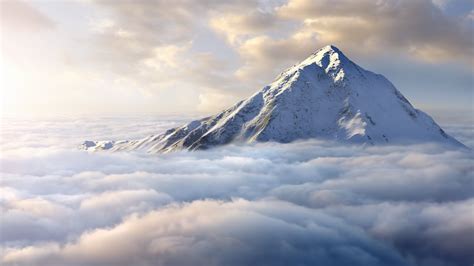 Snow-covered mountaintop above clouds | Windows Spotlight Images