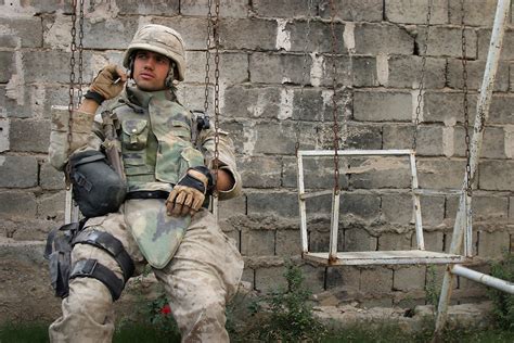 A Marine from Kilo Company, 3rd Battalion, 1st Marines takes a break in ...