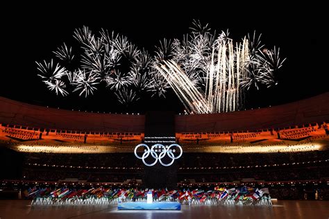 Opening ceremony ends with Uyghur skier lighting cauldron | Reuters